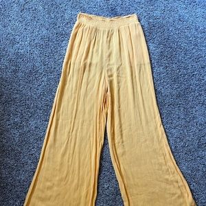 Yellow flowy pants with pockets and an elastic waistband